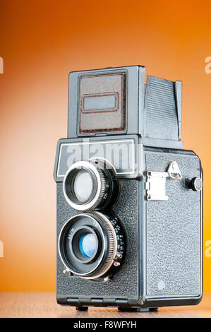 Vintage film camera against gradient background Stock Photo