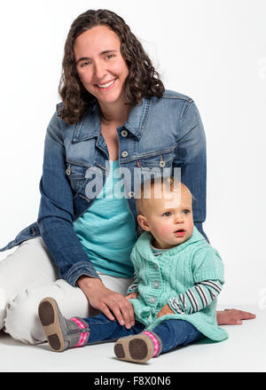 Studio photograph of young Caucasian mother and cute one year old baby girl Stock Photo