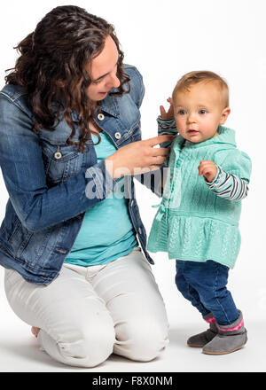 Studio photograph of young Caucasian mother and cute one year old baby girl Stock Photo