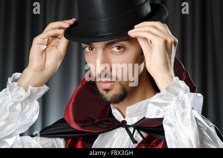 Magician doing tricks on white Stock Photo