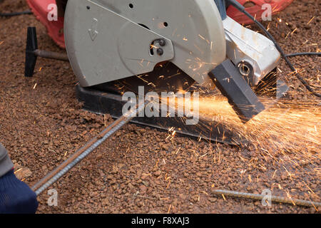 Cutting metal with grinder. Sparks while grinding iron Stock Photo