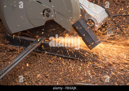 Cutting metal with grinder. Sparks while grinding iron Stock Photo