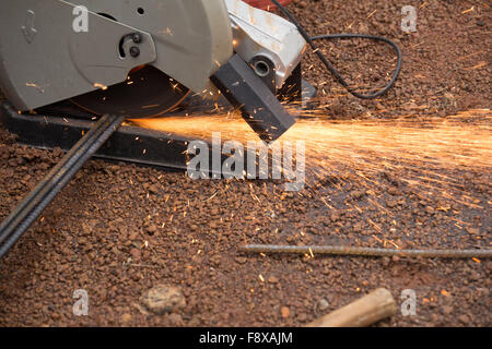 Cutting metal with grinder. Sparks while grinding iron Stock Photo