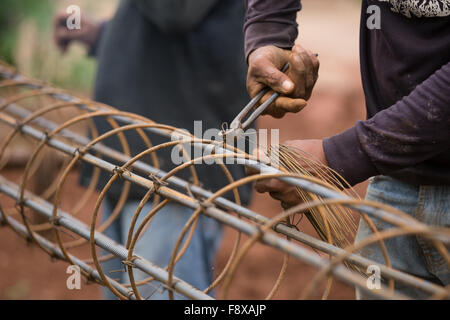 technician bundle wire steel rod for construction job Stock Photo