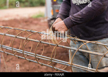 technician bundle wire steel rod for construction job Stock Photo