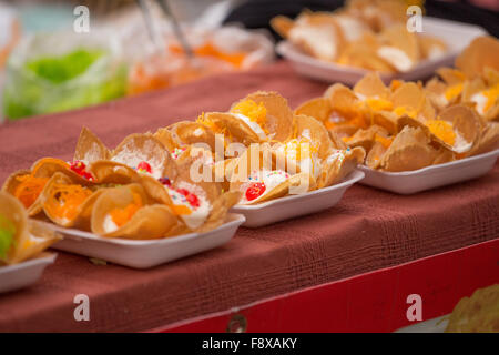 Thai Traditional Snack and Dessert, Thai Crispy Pancake or Thai Crepes Filled with Sweet Coconut Cream (Kanom Buang) Stock Photo