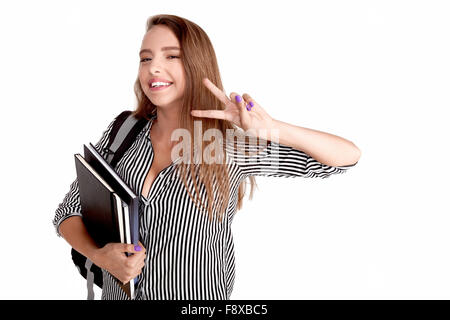 Young cheerful woman student doing victory sign by fingers Stock Photo