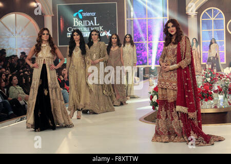 Pakistani models present creations of Pakistani designer Hassan