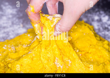 Hand in Saffron Bun Dough Stock Photo