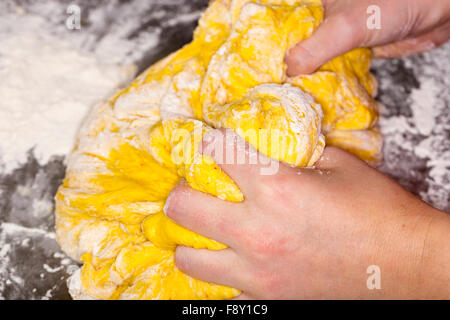 Hands in Saffron Bun Dough Stock Photo