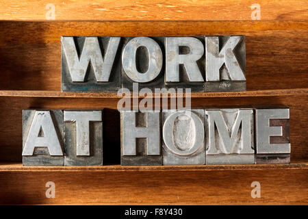 work at home phrase made from metallic letterpress type on wooden tray Stock Photo