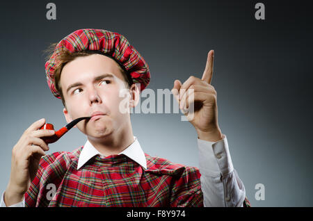 Funny scotsman smoking pipe tobacco Stock Photo