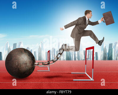 Businessman jumping over barrier Stock Photo