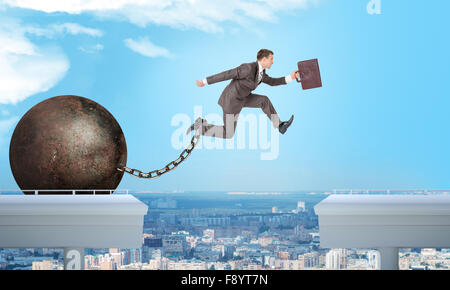 Image of young businessman jumping over gap Stock Photo