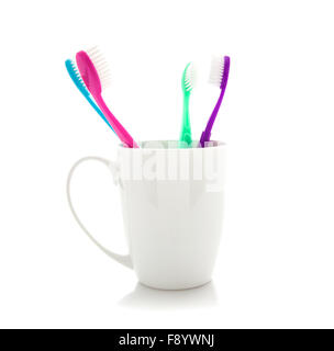 Assorted Tooth Brushes in holder on white background Stock Photo