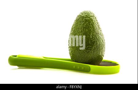 Avocados with slicer isolated on white background Stock Photo