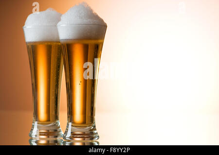 Beer glasses against the colorful gradient background Stock Photo