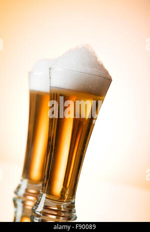 Beer glasses against the colorful gradient background Stock Photo