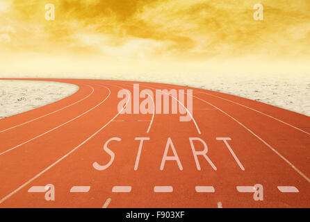 empty outdoor running track with sign start with desert at sunset Stock Photo