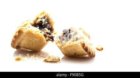 Mince Pie broken in half showing mince on white background Stock Photo