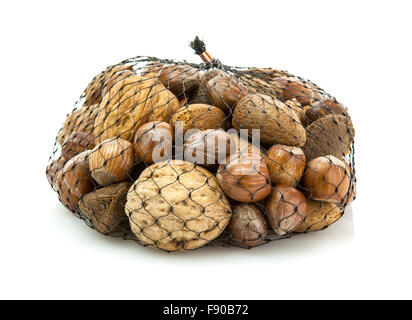 Mix nuts - walnuts, hazelnuts, almonds in a net bag on a white background Stock Photo