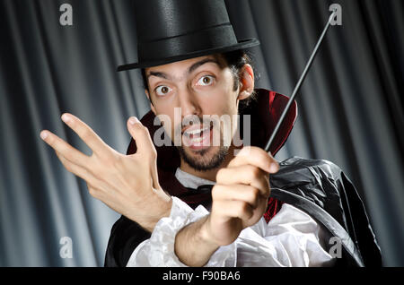 Magician doing tricks on white Stock Photo