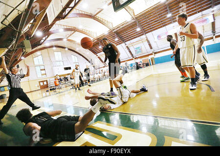Angwin, CA, USA. 11th Dec, 2015. The referee signals a foul after Pacific Union College's Devon Marshall, bottom left, and Johnson & Wales' Andrew Bonner, center, went down during the Pioneers game against Johnson & Wales University at Pacific Union College in Angwin on Friday. © Napa Valley Register/ZUMA Wire/Alamy Live News Stock Photo