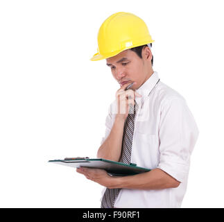 engineer thinking and looking on clipboard isolated on white background Stock Photo