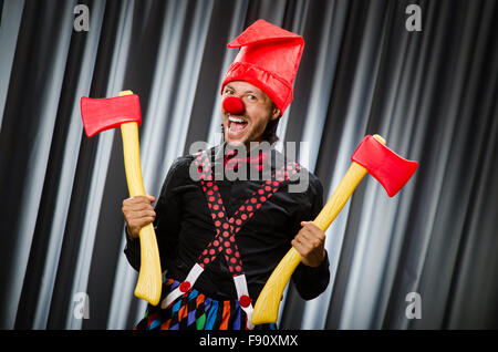 Funny clown with red axe Stock Photo