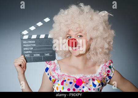 Clown with movie clapper board Stock Photo