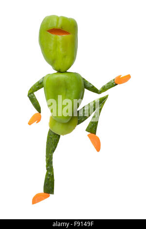Green ninja made of vegetables kicks with a knee on isolated background Stock Photo