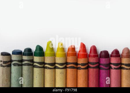 group of old wax crayons on white paper - vintage crayons many colors Stock Photo