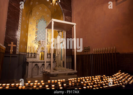 Prayer candles in the Basilica of our Lady of the Rosary in the Sanctuary of Our Lady of Lourdes Stock Photo