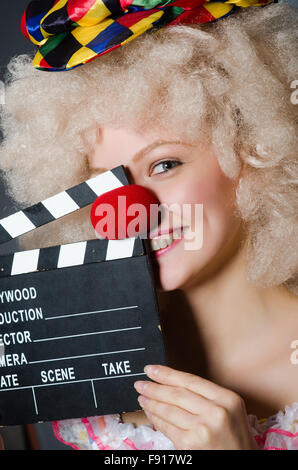 Clown with movie clapper board Stock Photo