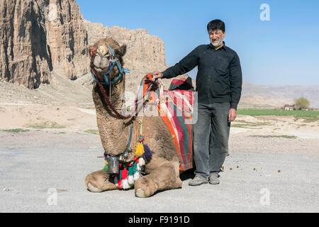 Kneeling dromedary and handler, Naqsh e Rostam, Mavdasht, Iran Stock Photo