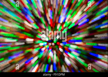 Holiday Christmas tree lights background in bright and colorful abstract motion blur zoom Stock Photo