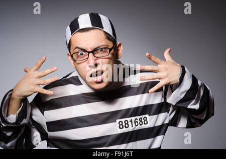 Funny prisoner isolated on gray Stock Photo