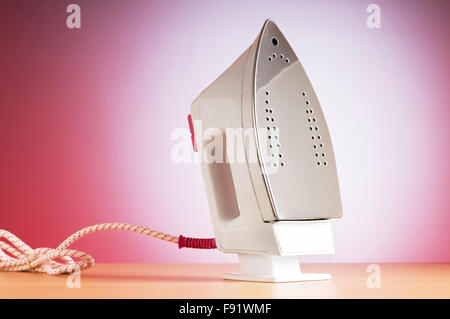 Modern electric iron against the colorful background Stock Photo