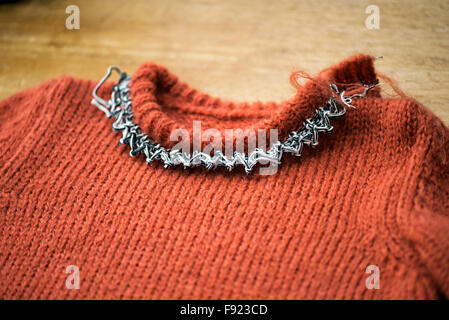 Working on woolen sweater collar in a knitwear factory Stock Photo