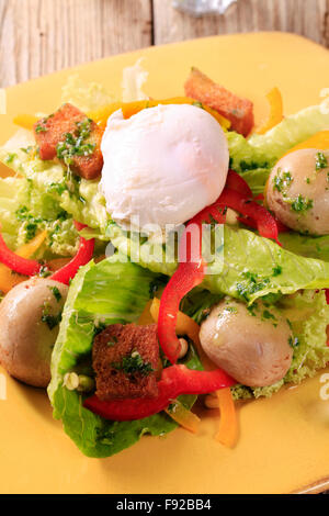 Vegetable salad with button mushrooms, croutons and poached egg Stock Photo