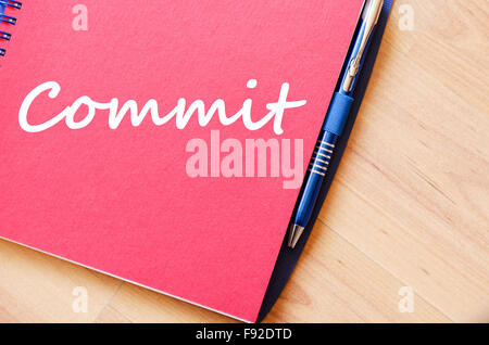 Commit text concept write on notebook with pen Stock Photo