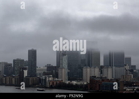 London, UK. 13th December, 2015. UK Weather: Afternoon fog clouds over Canary Wharf business park buildings and River Thames Credit:  Guy Corbishley/Alamy Live News Stock Photo