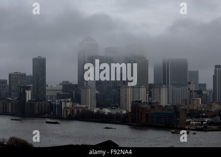 London, UK. 13th December, 2015. UK Weather: Afternoon fog clouds over Canary Wharf business park buildings and River Thames Credit:  Guy Corbishley/Alamy Live News Stock Photo