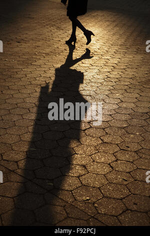 Abstract background of people's legs walking at night in streetlight Stock Photo