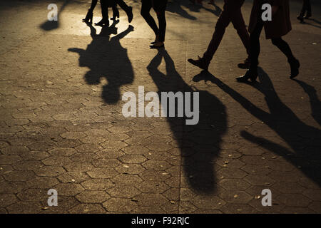 Abstract background of people's legs walking at night in streetlight Stock Photo