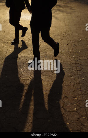 Abstract background of people's legs walking at night in streetlight Stock Photo