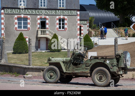 A Willys GPW Jeep parked outside the Dead Mans Corner Museum in Carentan, Normandy France Stock Photo