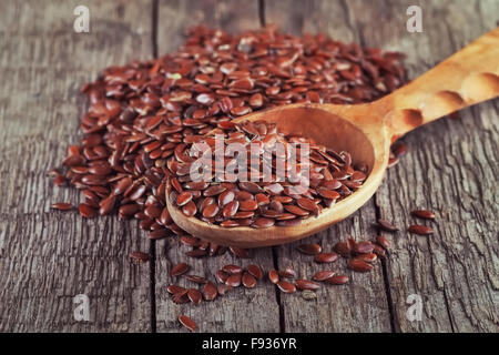flax seeds in spoon on vintage wooden background Stock Photo