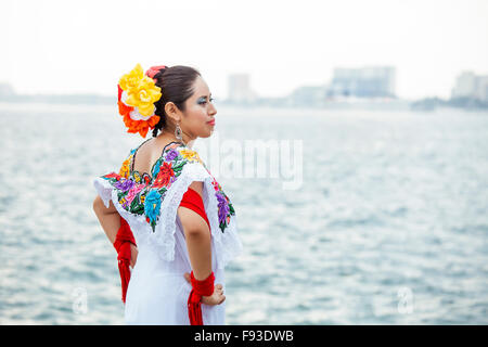 A folkloric dancer strikes a pose on the boardwalk in Puerto Vallarta, Mexico. Stock Photo