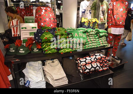 New York, NY, USA. 08th Dec, 2015. Eye-catching Christmas sweaters hang in a store at Herald Square in New York, NY, USA, 08 December 2015. Wearing not very tasteful Christmas sweaters has become a tradition in the USA. Even retailers now offer the flashy sweaters, which are quite popular at Christmas parties. Photo: Chris Melzer/dpa - NO WIRE SERVICE -/dpa/Alamy Live News Stock Photo
